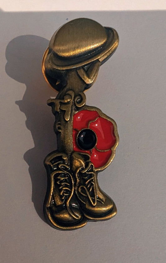 Soldier boots and poppy pin badge